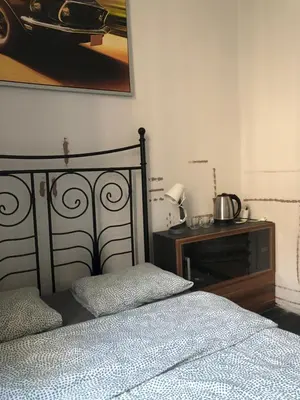 a bedroom with a bed and a picture on the wall at KRAKOWIAK in Kraków