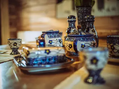 a table with blue and white vases on a table at Sękata Chata Zawoja in Zawoja