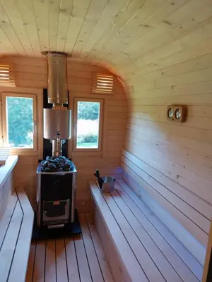 a inside of a wooden cabin with a stove in it at Sękata Chata Zawoja in Zawoja