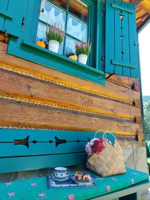 a table with a basket of fruit and a window at Sękata Chata Zawoja in Zawoja
