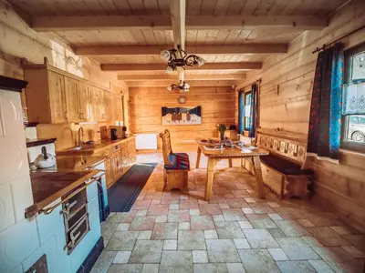 a kitchen with a table in the middle of it at Sękata Chata Zawoja in Zawoja