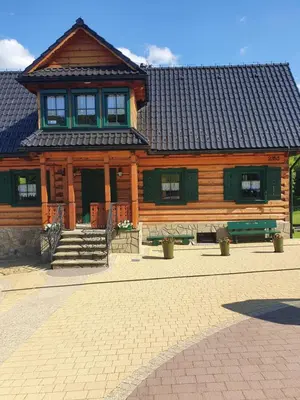 a large wooden house with a roof at Sękata Chata Zawoja in Zawoja