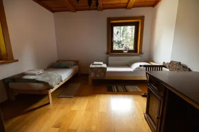 a living room with a bed and a window at Zbójnicka Chata in Wieliczka
