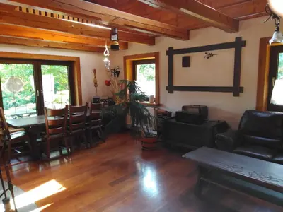 a living room with a couch and a table and chairs at Zbójnicka Chata in Wieliczka