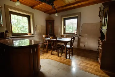 a kitchen and dining room with a table and chairs at Zbójnicka Chata in Wieliczka