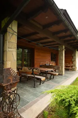 a patio with benches and a table on a house at Zbójnicka Chata in Wieliczka