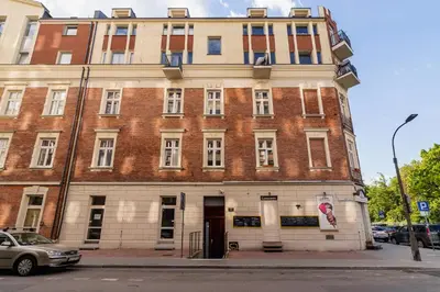 a large brick building on the corner of a street at Duplex Apartment Brandy Cracow by Noclegi Renters in Kraków