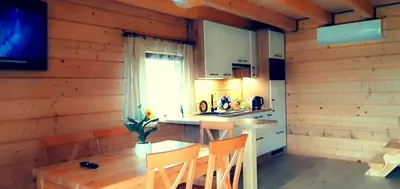 a kitchen with a table and chairs and a window at Chatki U Hanusi in Czchów