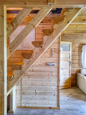 an attic staircase in a log cabin with wooden walls at Chatki U Hanusi in Czchów