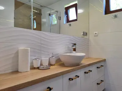 a bathroom with a sink and a mirror at Chatki U Hanusi in Czchów