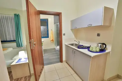 a small kitchen with a sink and a bathroom at Parkowy Dworek in Rabka