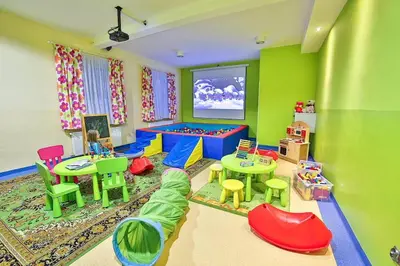 a childs room with colorful furniture and a play area at Parkowy Dworek in Rabka