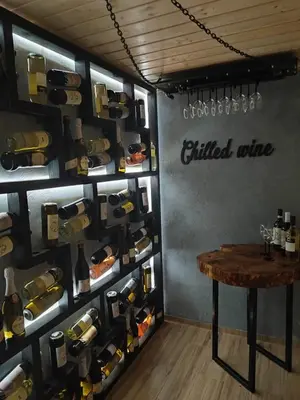 a wine cellar with a table and wine bottles at Dom na Leśnej in Po”łwieś