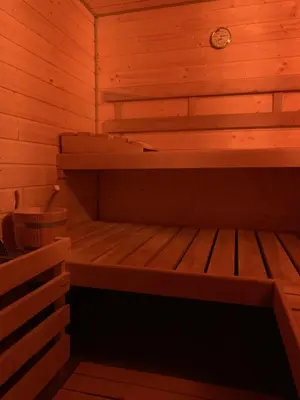 a small wooden sauna with a bench in it at Dom na Leśnej in Po”łwieś