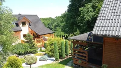 a house with a garden in front of it at Dom na Leśnej in Po”łwieś