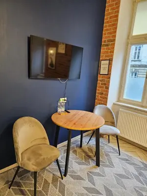 a table and two chairs in a room at JUWEL Uroczy Apartament 2A Stare Miasto Kraków in Kraków