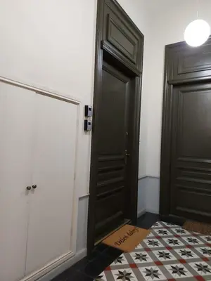 a hallway with a black door and a tile floor at JUWEL Uroczy Apartament 2A Stare Miasto Kraków in Kraków