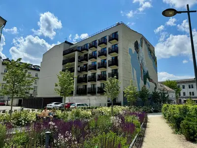 a building with a mural of a woman on it at Old Town - Rajska Signature Suites by Gio Loft in Kraków