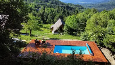 a group of people sitting around a swimming pool at Przysiółek Flądrówka - Dom na odludziu z widokiem na Gorce i Tatry in Szczawa