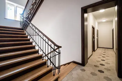 a staircase in a house with wooden railings at Mickiewicza Old Town Apartment WAWELOFTS in Kraków