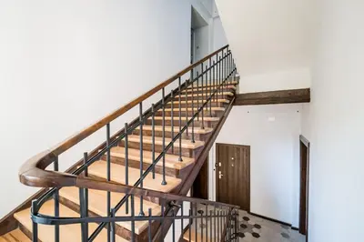 a spiral staircase in a house with white walls at Mickiewicza Old Town Apartment WAWELOFTS in Kraków