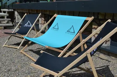 two lawn chairs sitting next to each other at Retro Domek - Domek z ogrodem w górach in Sułkowice