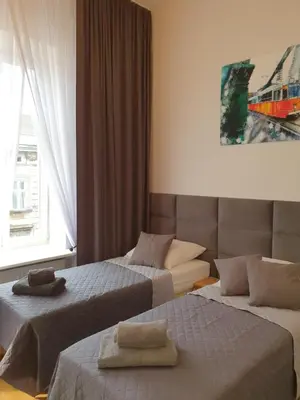 a hotel room with two beds and a window at Historic Old Town Kazimierz in Kraków