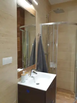 a bathroom with a sink and a shower at Historic Old Town Kazimierz in Kraków