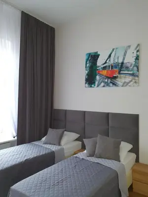 a hotel room with two beds and a painting on the wall at Historic Old Town Kazimierz in Kraków