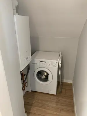 a washer and dryer in a small room at Hostel Pokoje 15G in Skawina