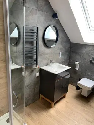a bathroom with a sink and a shower at Hostel Pokoje 15G in Skawina
