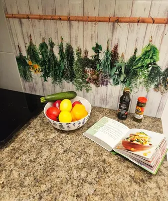 a bowl of fruit on a counter next to a book at Czar Prowansji - Comfy & Quiet near Rynek&Train Station Netflix in Kraków