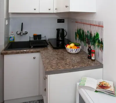 a kitchen with a bowl of fruit on a counter at Czar Prowansji - Comfy & Quiet near Rynek&Train Station Netflix in Kraków