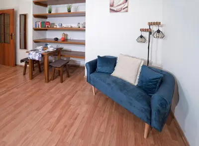 a living room with a blue couch and a table at Czar Prowansji - Comfy & Quiet near Rynek&Train Station Netflix in Kraków