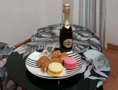 a plate of cheese and crackers and a bottle of beer at Czar Prowansji - Comfy & Quiet near Rynek&Train Station Netflix in Kraków