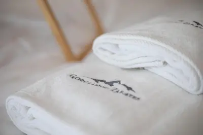 a white towel with a picture of a house on it at Villa Gorczański Zakątek Agroturystyka in Konina