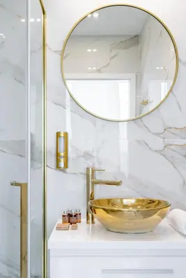 a bathroom with a gold sink and a mirror at Aquila Hotel in Zator