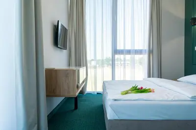 a hotel room with a bed with vegetables on it at Aquila Hotel in Zator