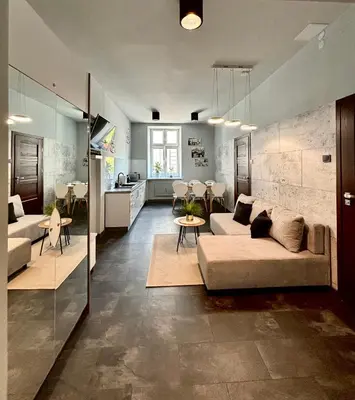 a living room with a couch and a table at Apartament Papieski in Wadowice