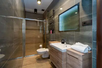 a bathroom with a sink and a toilet and a shower at Apartament Papieski in Wadowice