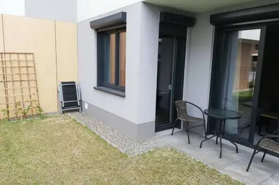 a patio with chairs and a table next to a building at Apartament na Rydlówce in Kraków