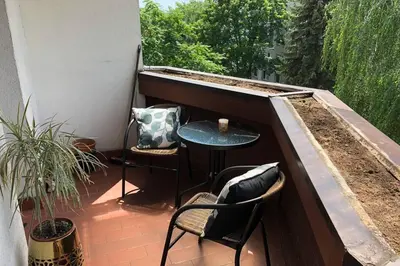 a patio with a table and chairs on a balcony at Apartament Siewna-moje miejsce na idealne wakacje in Kraków