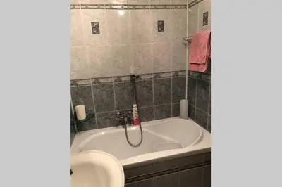 a bathroom with a bath tub and a sink at Apartament Siewna-moje miejsce na idealne wakacje in Kraków