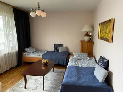 a living room with two beds and a table at Apartament Siewna-moje miejsce na idealne wakacje in Kraków
