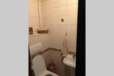 a bathroom with a toilet and a sink at Apartament Siewna-moje miejsce na idealne wakacje in Kraków