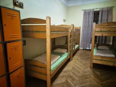 a room with three bunk beds and a hallway at 50 People Apartment in Kraków