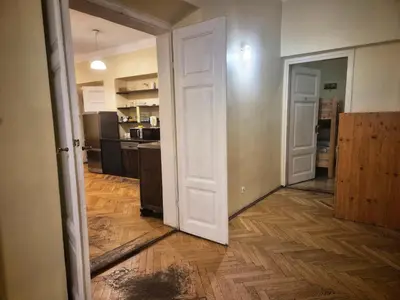 an open door in a room with a kitchen at 50 People Apartment in Kraków