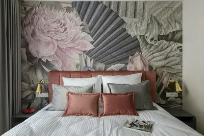 a bedroom with a bed with a floral wallpaper at Flav Apartment in Kraków