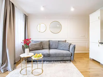 a living room with a couch and a table at Golden Star Apartment in Kraków