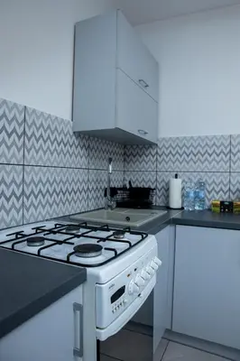 a white stove top oven in a kitchen at Lovely place-apartament Oświęcim in Oświęcim